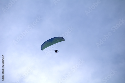 paraglider in the sky,motorized, sport, fly, blue, paraglider,extreme, flying, adventure, air, freedom, gliding,activity, wind, high, 