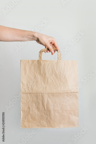 Zero waste. Paper shopping bag in women's hand.