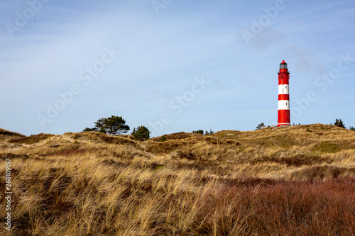 Red lighthouse on the hill in distance