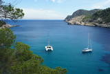 Landscapes of the island of Ibiza. Yachts in the sea bay.