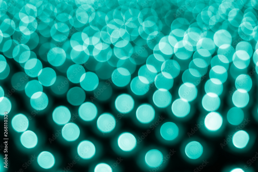 Fototapeta premium Abstract bokeh background. Soft defocused lights. Neon basic cyan color
