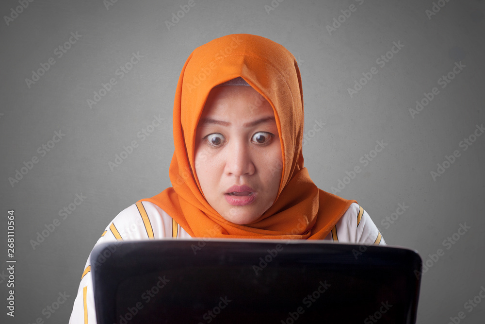 Muslim Businesswoman Working on Laptop Shocked Stunned gesture
