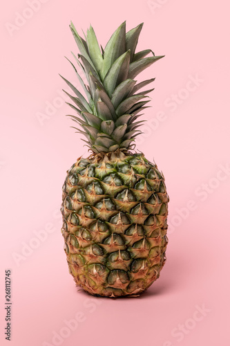 sweet fresh tasty and raw pineapple with green leaves on pink