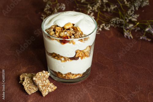 Healthy breakfast with granola and homemade yogurt in a glass. Rustic style	