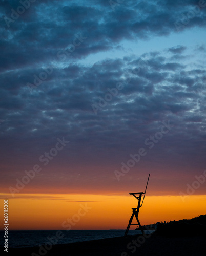 Sunset on a Mediterranean beach, next to a coastal surveillance post