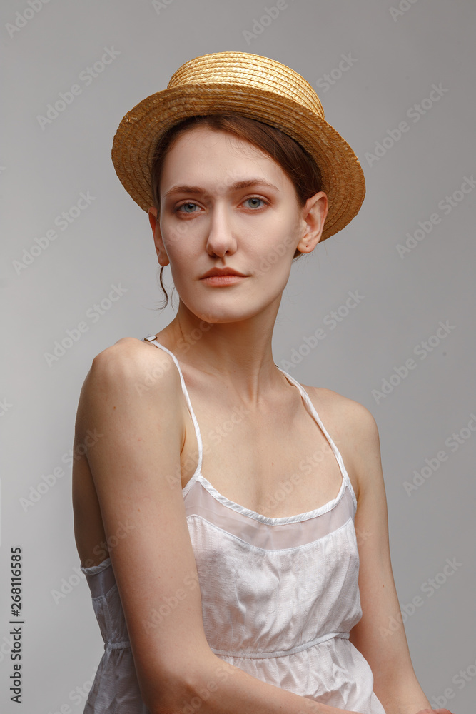 Portrait of a young attractive girl in a straw hat. Portrait of a young attractive girl in a straw hat.