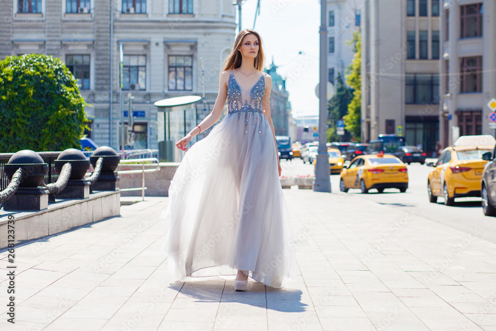 Obraz premium Young beautiful blonde woman in summer white dress