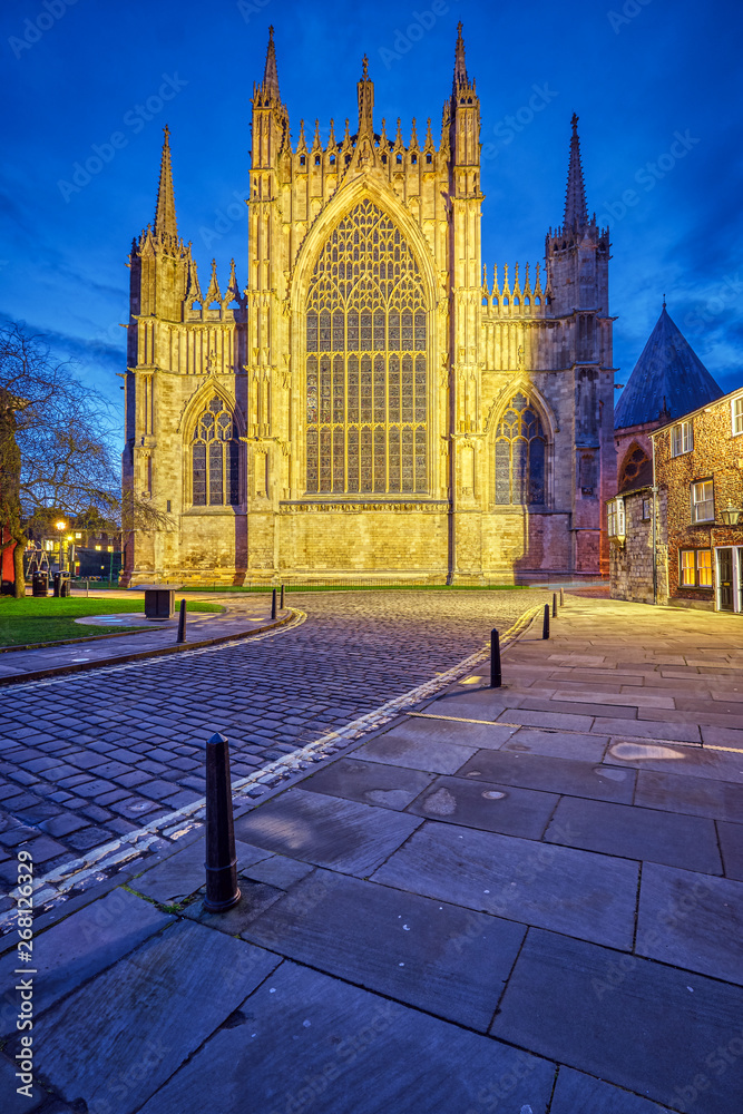 Fototapeta premium The backside of the York Minster and some half-timbered houses at dusk
