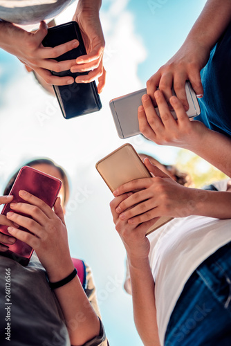 Kids playing video games on smart phone after school photo