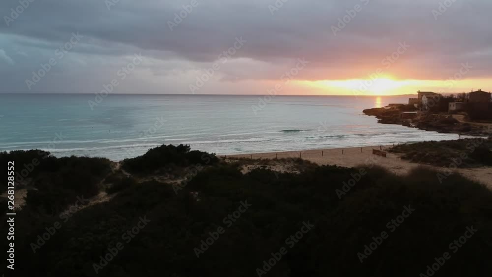 Drone flying over tropical island of Mallorca, Spain out over the beach towards a beautiful sunset Drone flying over tropical island of Mallorca, Spain out over the beach towards a beautiful sunset