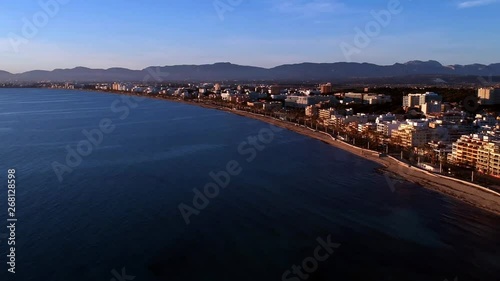 Wallpaper Mural Drone flying over the water off the coast of a city on the island of Mallorca Spain during sunset Torontodigital.ca