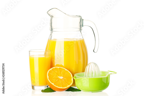 Jug, glass of fresh orange juice, juicer and orange fruits with green leaves on white background