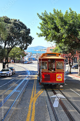The streets of San Francisco: The iconic cable car travelling up Hyde Street with Alcatraz in the background