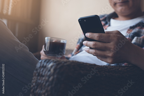 Man using smartphone at coffee shop