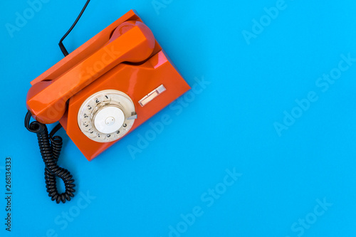  Orange telephone on blue background