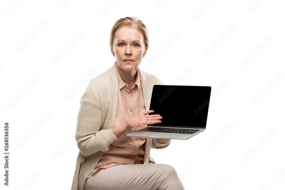 confused middle aged woman holding laptop with blank screen and Gesturing Isolated On White confused middle aged woman holding laptop with blank screen and Gesturing Isolated On White