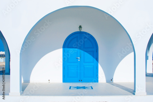 Details of white Ayia Thekla Chapel with blue arched doors