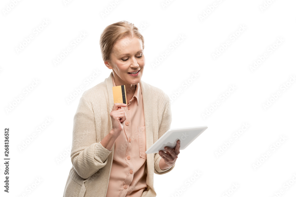 smiling middle aged woman with credit card using Digital Tablet Isolated On White smiling middle aged woman with credit card using Digital Tablet Isolated On White