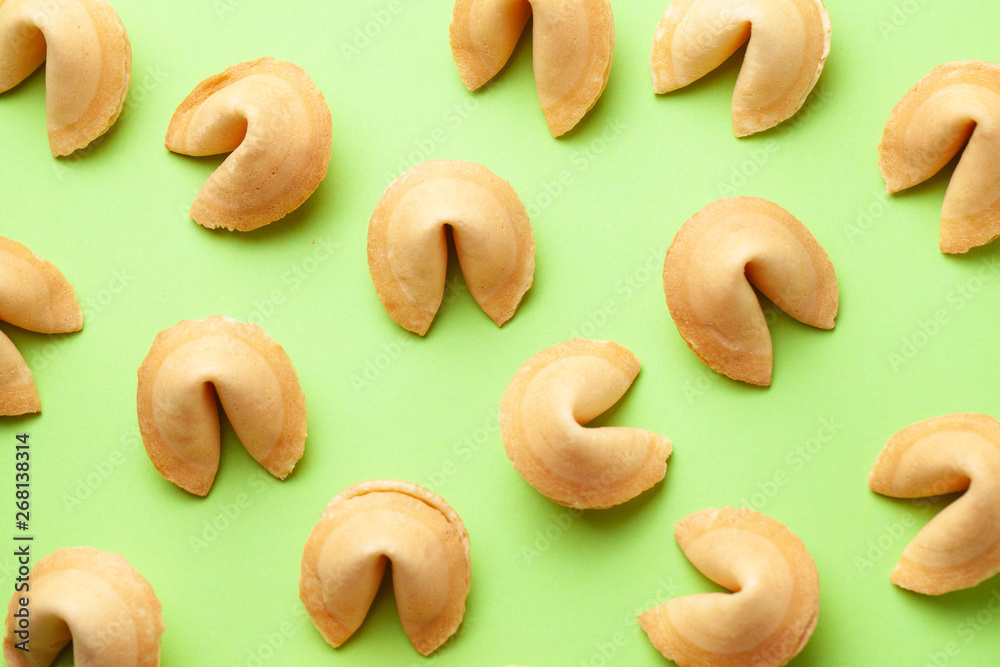 Chinese fortune cookies. Cookies texture pattern with empty blank inside for word prediction. Green background.