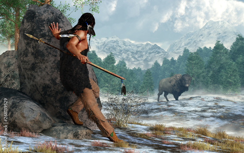 A prehistoric Native American hunter wearing furs and carrying a atlatl and spear stalks a bison in a snow covered valley in the Rocky Mountains. 3D Rendering photo