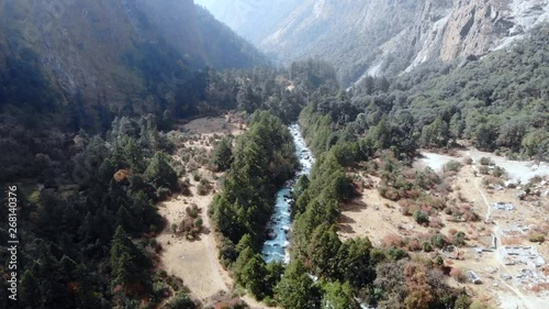 4k aerial fly through green valley with river in Langtang Valley in Nepal
