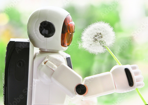 The robot is holding a white, fluffy dandelion.