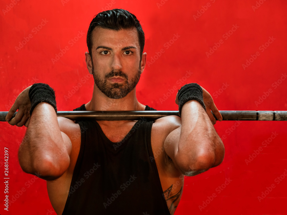 man lifting a barbell at the crossfit gym man lifting a barbell at the crossfit gym