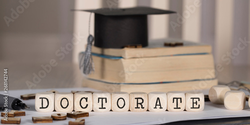 Word DOCTORATE composed of wooden dices.