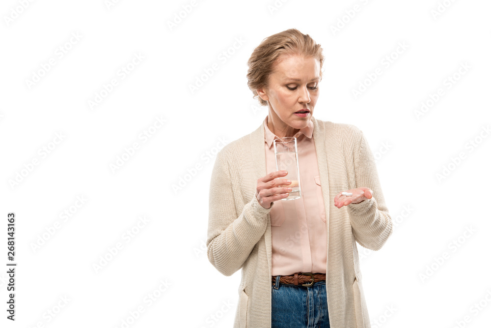 Obraz premium middle aged woman with glass of water and pills Isolated On White with copy space