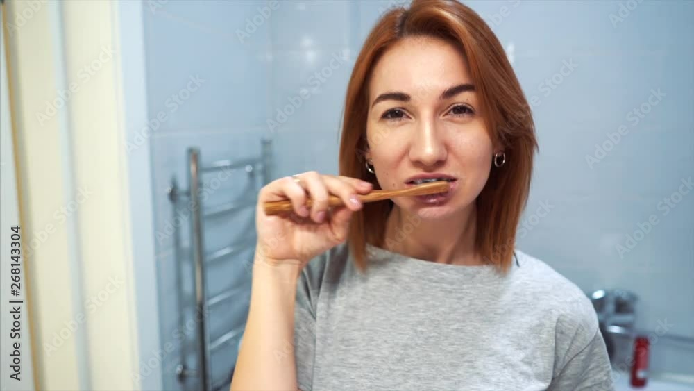 Pretty young woman in the bathroom brushing her teeth Pretty young woman in the bathroom brushing her teeth