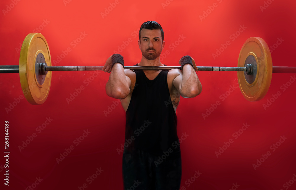 man lifting a barbell at the crossfit gym man lifting a barbell at the crossfit gym