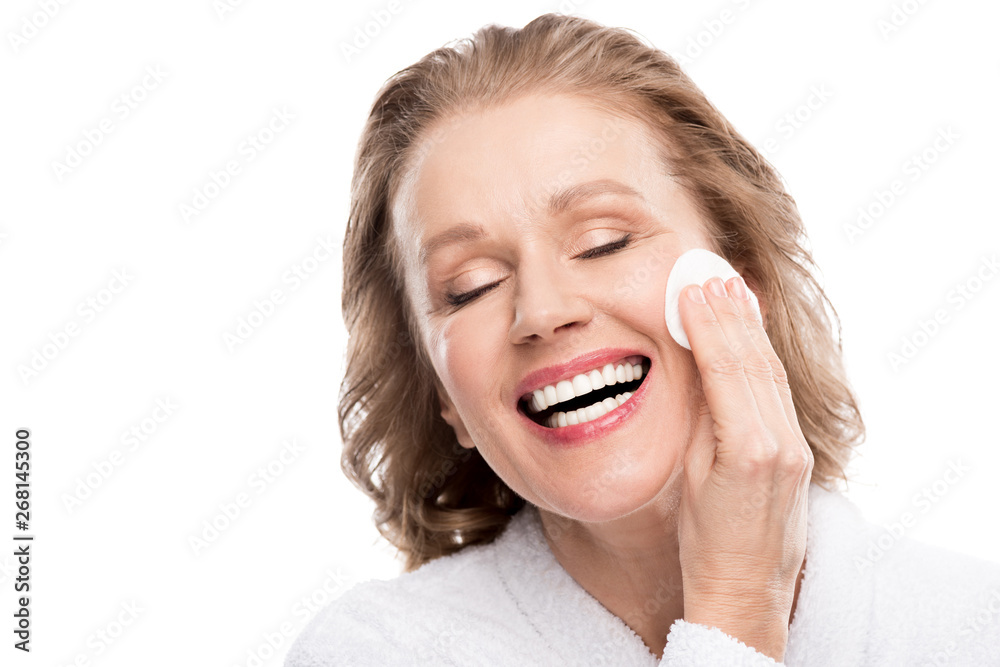 smiling mature woman wiping face with cotton pad Isolated On White smiling mature woman wiping face with cotton pad Isolated On White