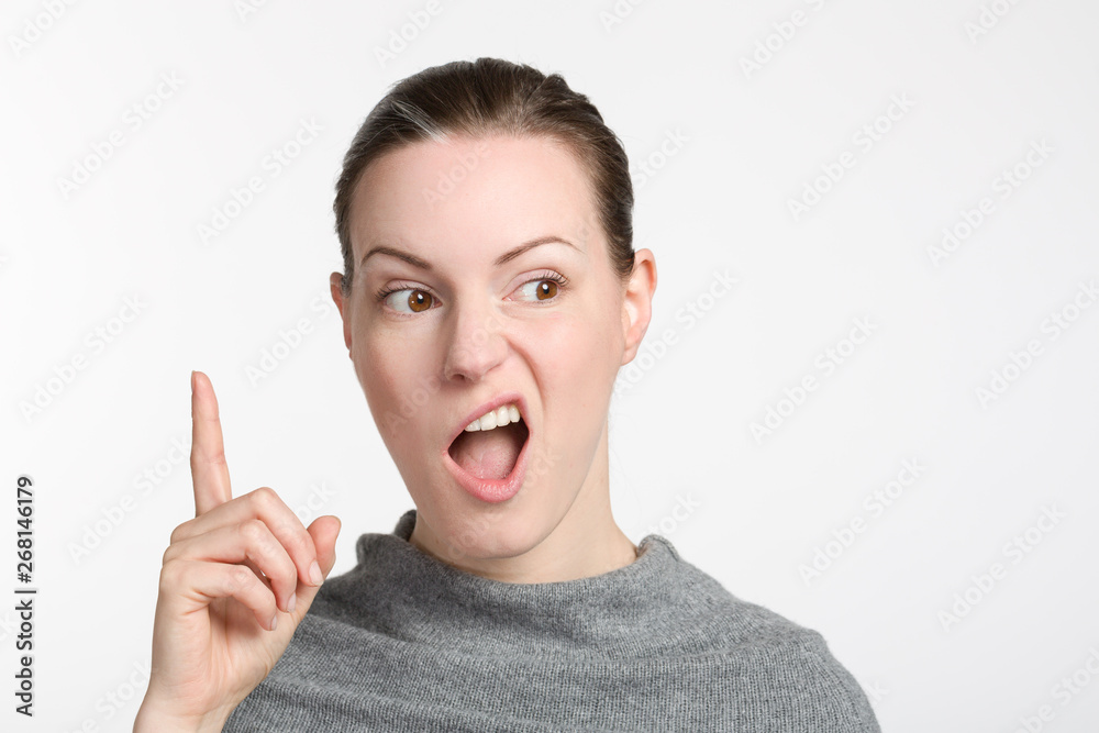 young woman rises her trigger finger and grimaces young woman rises her trigger finger and grimaces