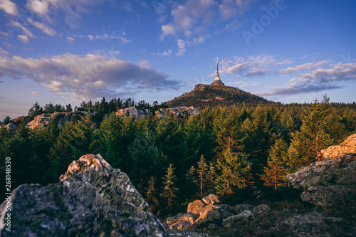 View of a sunrise or sunset landscape of Jizerske mountains and the top of Jested mountain. Rocks, forest and dramatic sky over the Jested summit. photo