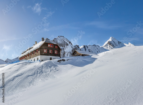 Wooden mountain hut in the alps in winter