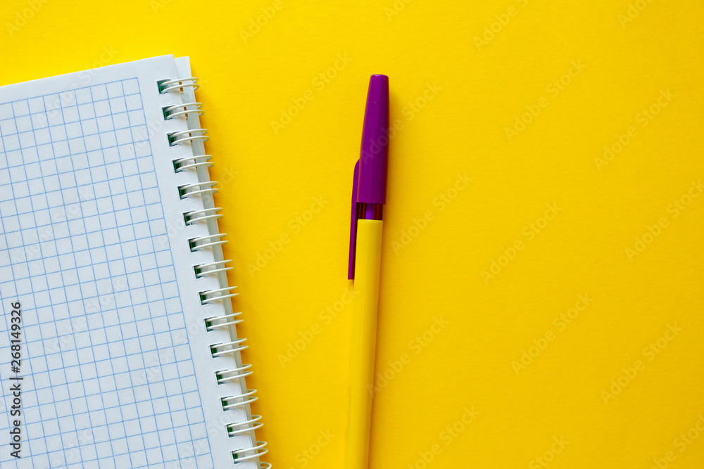 School notebook with pencil on yellow background. Blank notebook page for input the text in the middle. Top view,business, office supplies or education concept.School office supplies.minimal style. School notebook with pencil on yellow background. Blank notebook page for input the text in the middle. Top view,business, office supplies or education concept.School office supplies.minimal style.
