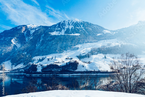 Beautiful winter lake and snowy mountains. Winter landscape © EwaStudio