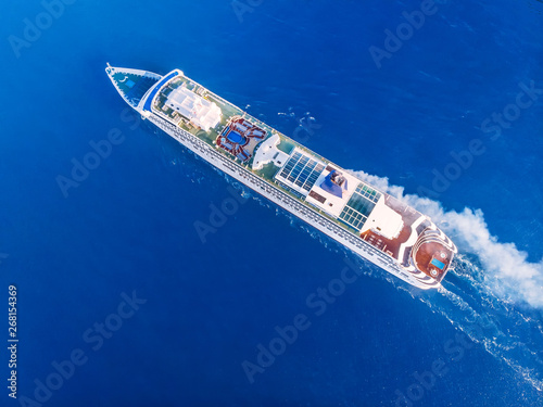 Cruise liner ship across ocean with blue water. Aerial top view. Concept travel tour © Parilov