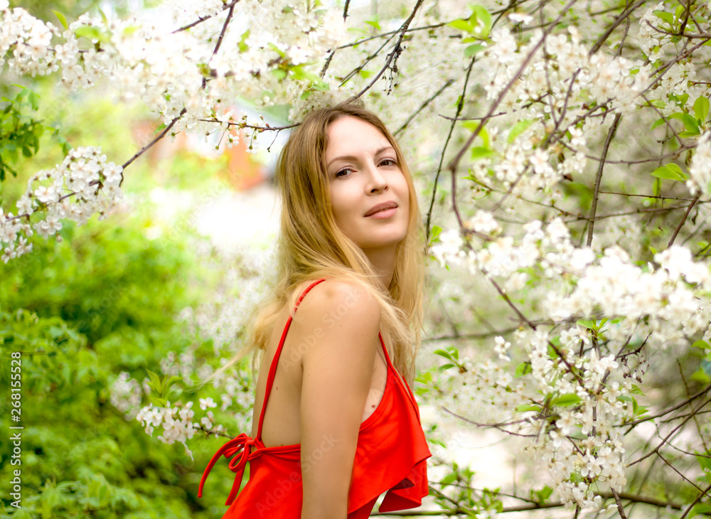 Portrait of a beautiful girl among spring foliage and flowers Portrait of a beautiful girl among spring foliage and flowers