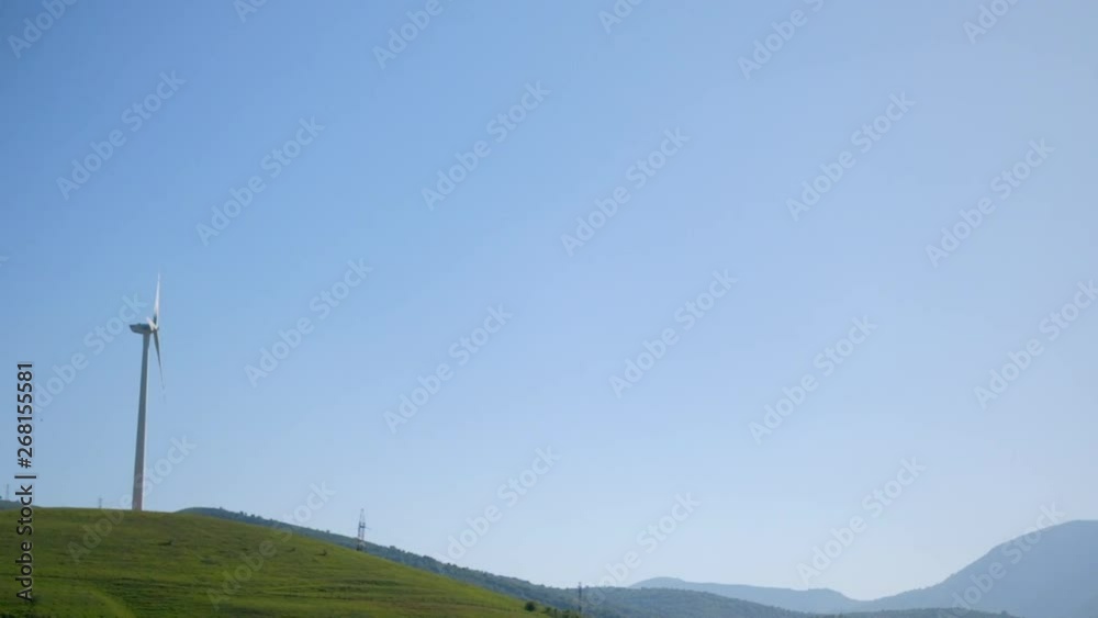 Wind turbine is working on the top of the mountain Wind turbine is working on the top of the mountain