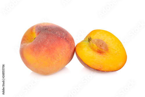 whole and half cut ripe peach on white background