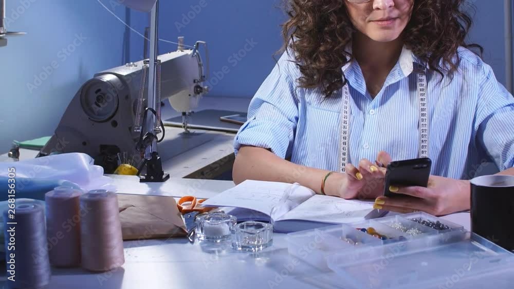 Designer coming up with a sketch of clothes and making sketches on paper. Sewing Business.