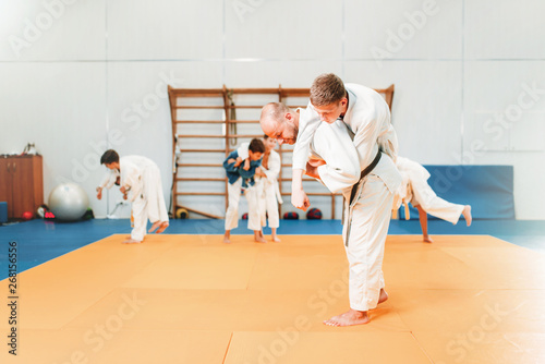 Kid judo, young fighters on training in hall