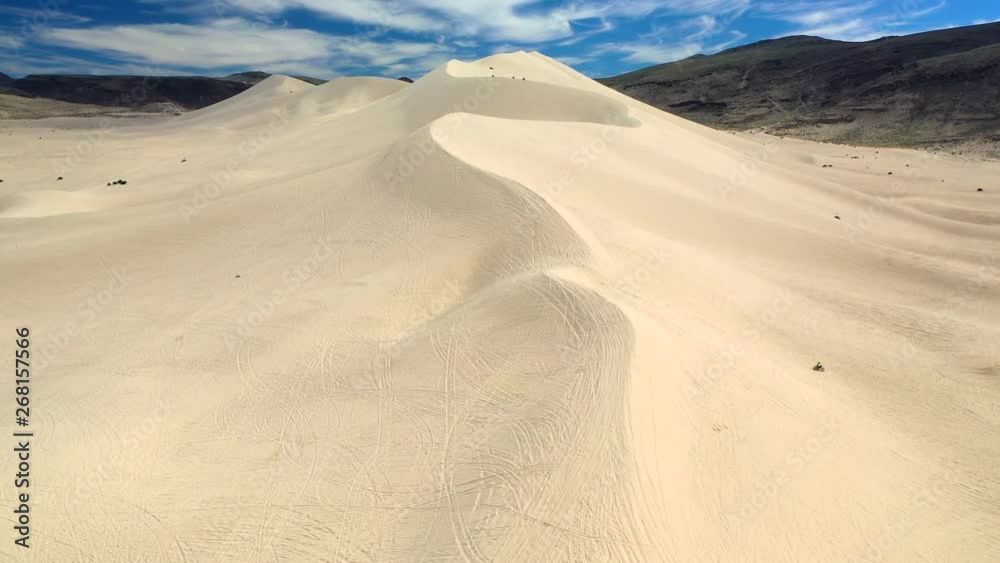 Aerial, drone shot towards dune buggies, driving on large dunes, on sunny day, in Sand Mountain Recreation Area, in Nevada, USA Aerial, drone shot towards dune buggies, driving on large dunes, on sunny day, in Sand Mountain Recreation Area, in Nevada, USA