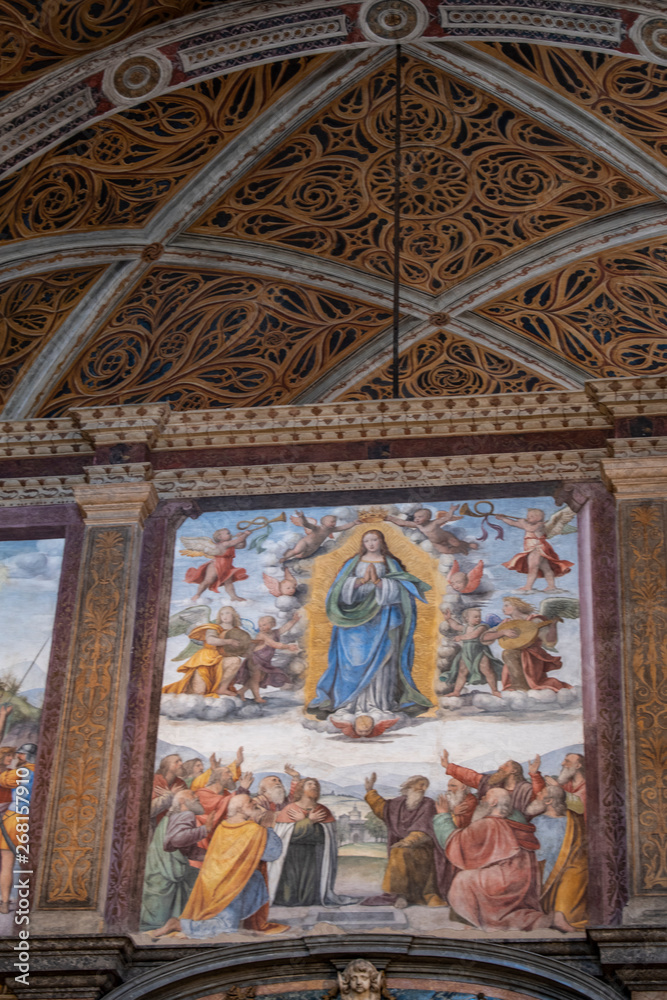 Italy, 03/28/2019: San Maurizio al Monastero Maggiore, 1518 church known as the Sistine Chapel of Milan, details of altarpiece and dividing wall in the faithful's area with frescoes by Aurelio Luini