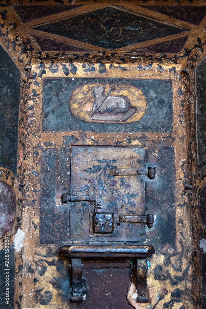 Italy, 28/03/2019: San Maurizio al Monastero Maggiore, 1518 church known as the Sistine Chapel of Milan, the opening for the passage of the sacramental bread on the dividing wall in the Hall of nuns Italy, 28/03/2019: San Maurizio al Monastero Maggiore, 1518 church known as the Sistine Chapel of Milan, the opening for the passage of the sacramental bread on the dividing wall in the Hall of nuns