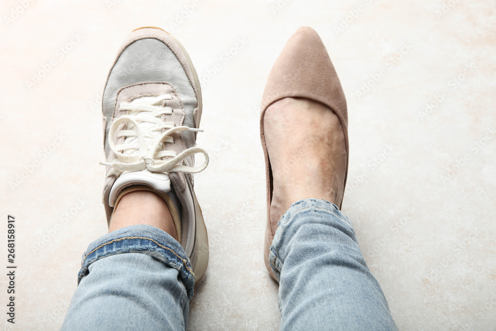 legs in sports shoe and beautiful elegant classic shoes legs in sports shoe and beautiful elegant classic shoes