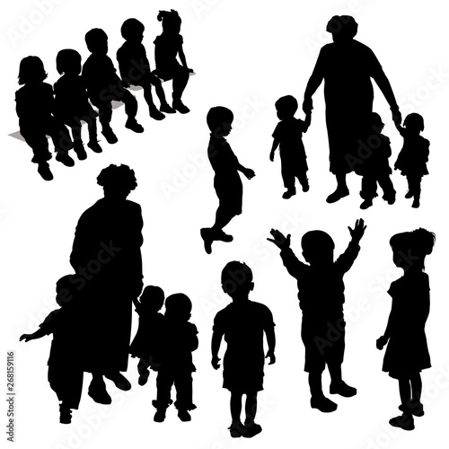 Vector silhouettes of a group of preschoolers. Children sit, the boy joyfully raised his hands up  the girl stands, the silhouette of the boy sideways, the woman tutor mother holds the children’s hand