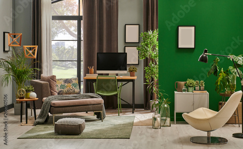 Modern living room with grey sofa and frame, green wall close up decoration in front of the window. photo