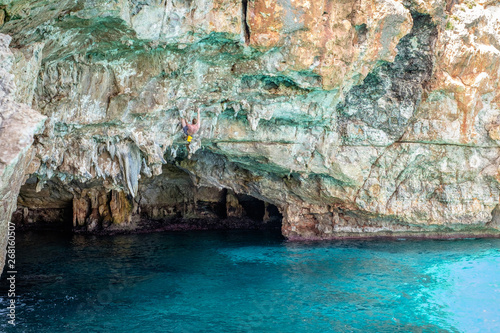 Beautiful ocean place in Mallorca, Spain. Cliffs and ocean. Deep water solo. Cala barques. Climber on the rock.